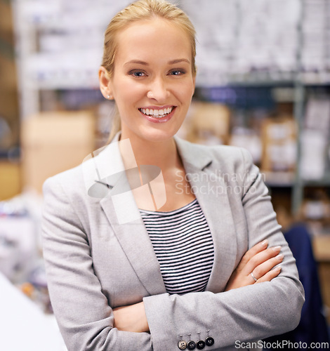 Image of Happy woman, portrait and manager with confidence at warehouse for storage, inventory or management. Confident female person or employee with smile and arms crossed for distribution or supply chain