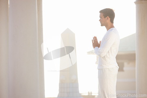 Image of Man, sun and meditation for yoga outdoor, zen and wellness with prayer hands for spiritual and holistic healing. Calm, peace and natural light with fresh air, mindfulness and energy balance for aura