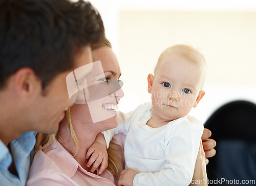 Image of Mother, father and baby for love embrace in home as childhood development, security or bonding. Man, woman and kid connection together as family or morning hugging with parent joy, comfort or support