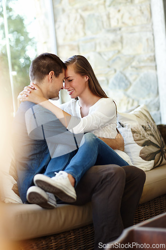 Image of Home, couple and forehead for love, embrace and romance or care on couch in living room. Happy people, touch and smile for pride in relationship or commitment, loyalty and connection on hug date