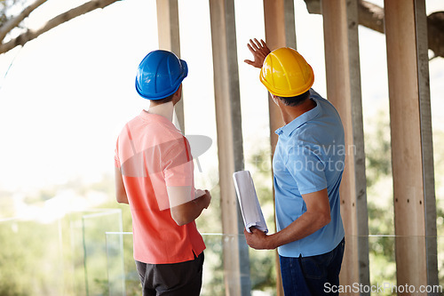 Image of Building, construction and architect with man on site for inspection, project management and planning. Professional contractor, engineer or developer with blueprint, pointing and design from back