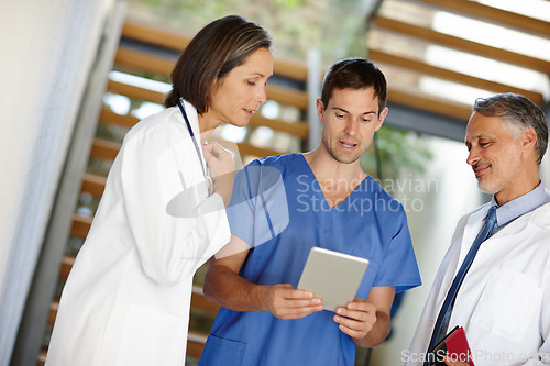 Image of Medical, team and conversation or working with tablet, hospital nurse with doctor in discussion for patient results. Health, collaboration on tech for research, consulting surgeon on healthcare