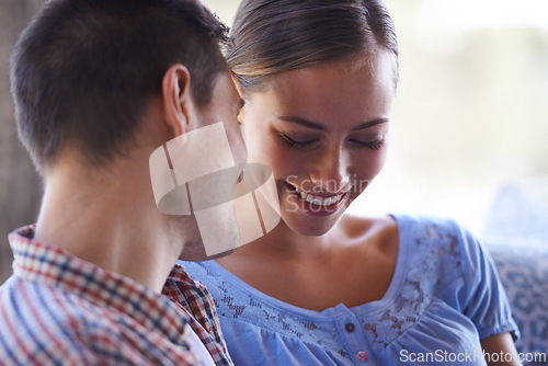 Image of Home, couple and conversation on couch for love, marriage and romance or care in living room. Happy people, talking and smile for pride in relationship or commitment, loyalty and connection on date