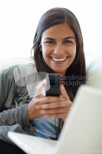 Image of Portrait, cellphone and laptop for female person, texting and couch at home for relax. Technology, social media and computer or streaming or online, mobile networking or communication on sofa