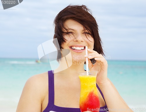 Image of happy woman with colorful cocktail