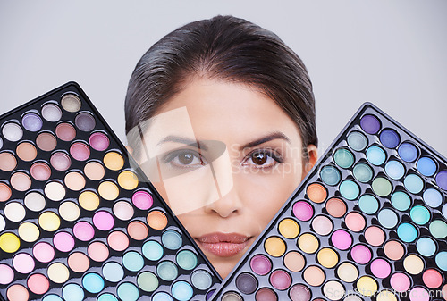 Image of Woman, portrait and makeup palette in studio for beauty cosmetics on grey background, transformation or makeover. Female person, face and facial products for skincare confidence, mockup or self care