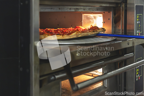 Image of Delicious pepperoni pizza on a metal peel