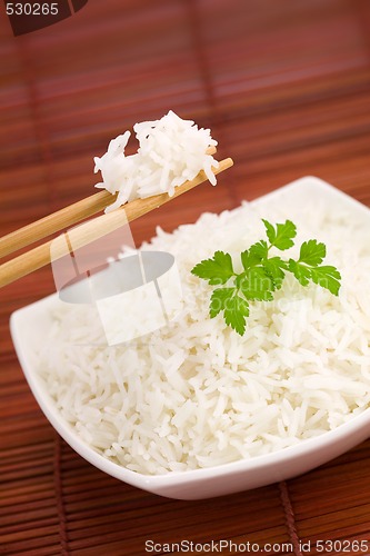 Image of Bowl of rice on mat