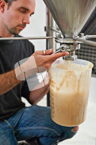 Image of Brewery, man and tap on machine with craft beer for sample, alcohol test or production process in factory. Industrial industry, worker hands or working in distillery with jug for brewing in warehouse