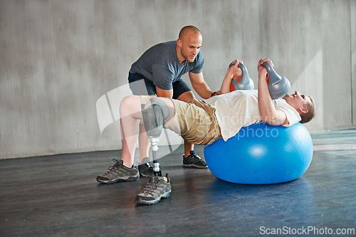 Image of Physiotherapy, patient or man with disability and kettlebells for exercise at gym for recovery, strength and healthcare rehabilitation. Physiotherapist, help or support and consultation for amputee