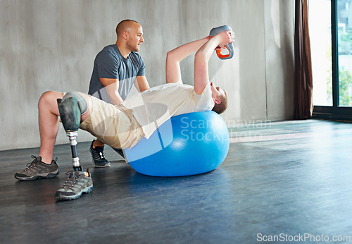 Image of Physiotherapy, disability and patient with kettlebell or exercise ball at gym for recovery, strength and healthcare rehabilitation. Physiotherapist, wellness and support or consultation for amputee