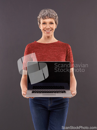 Image of Elderly, woman and laptop screen in studio with smile, technology and online search or typing and internet connection. Information, browse or social network, senior female person on mockup background