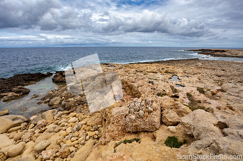 Image of Qawra Point Beach with turquoise waters nearby. Malta