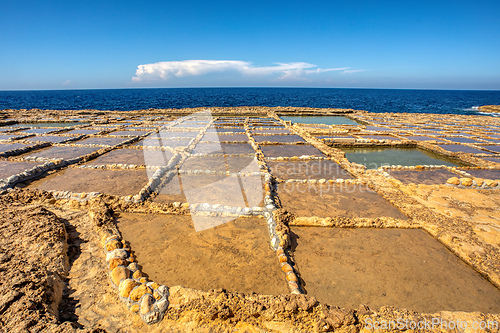 Image of Traditional salt pans in Xwejni Bay on the beach of island of Gozo, Malta.
