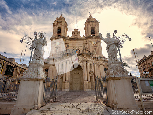 Image of Majestic Zabbar Parish Church in Malta against the evening sky at sunset.