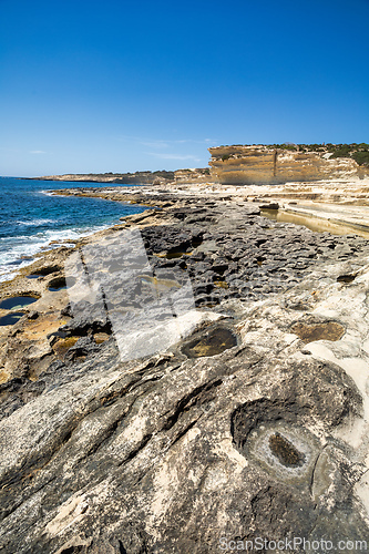 Image of Crystal clear turquoise water in blue lagoon. St. Peters pool - rocky beach at Malta