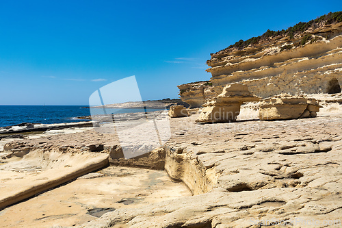 Image of Crystal clear turquoise water in blue lagoon. St. Peters pool - rocky beach at Malta