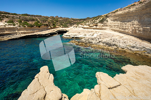 Image of Crystal clear turquoise water in blue lagoon. St. Peters pool - rocky beach at Malta