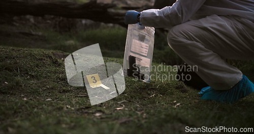 Image of Crime scene, gun and investigator with evidence outdoor for forensics, analysis and investigation in forest or nature. Person hands with weapon, ppe and inspection or police search for clues in woods