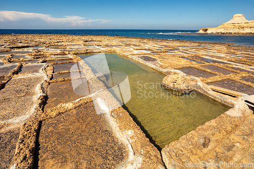Image of Traditional salt pans in Xwejni Bay on the beach of island of Gozo, Malta.