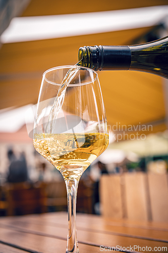 Image of Pouring white wine into a glass