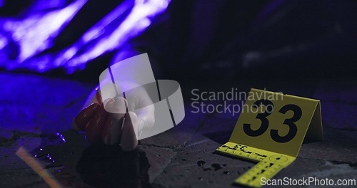 Image of Crime scene, dead body and accident at night in street with police sign and cover with and emergency siren. Death, person or murder or yellow cone in road with lights or blood with accident or corpse