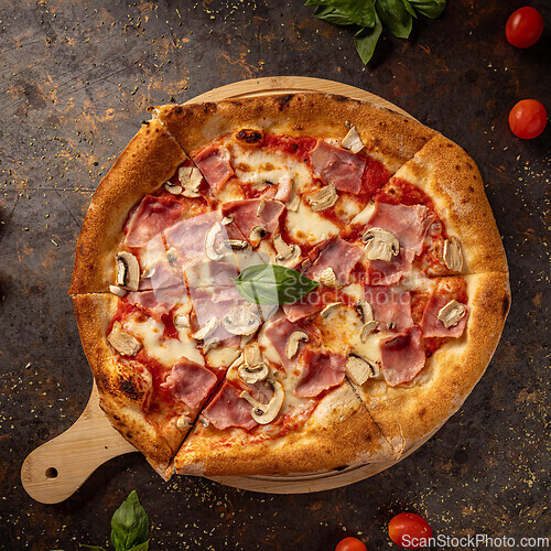 Image of Delicious pizza with ham and mushrooms