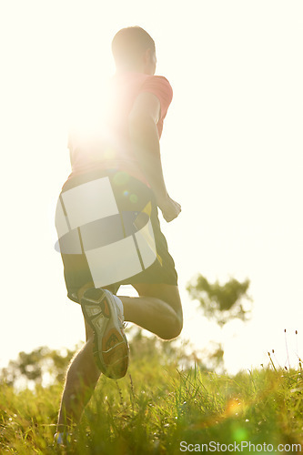 Image of Man, trail running and outdoors with athlete for endurance with training for physical fitness with lens flare. Male person, cross country and back for workout routine with balance in performance