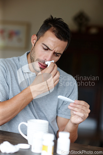 Image of Man, thermometer for temperature and sick with tissue for runny nose, sinus or hayfever with virus at home. Health fail, medication or pills with flu, monitor condition for allergies and infection