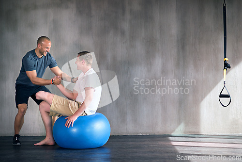 Image of Amputee, exercise ball and rehabilitation with physiotherapist at gym for training with motivation. Fitness, professional and patient with disability for wellbeing with workout, health and happy