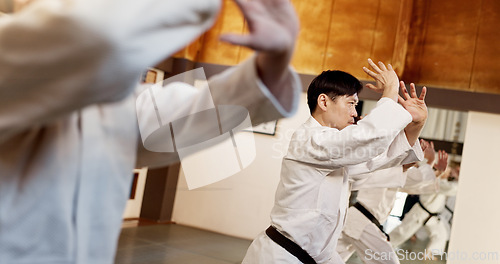 Image of Aikido class, group and people for martial arts, strike or together for combat at training, gym or dojo. Black belt students, fight and exercise for workout, fitness and conflict at Japanese club