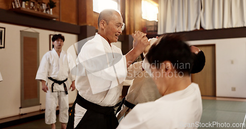 Image of Aikido class, man and sensei for martial arts, learning and advice for combat at training, gym and dojo. Japanese people, master and sports with fight, workout and fitness for zen, conflict or club