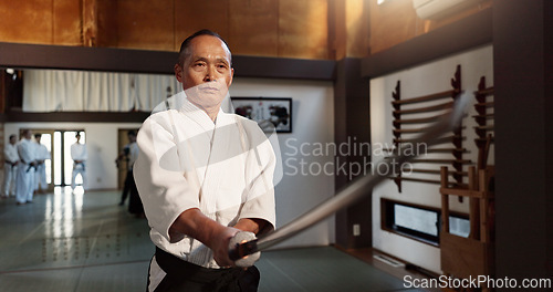 Image of Japanese master, aikido or martial arts by sword, lesson in combat or teacher of self defence. Sensei, black belt or katana in dojo place, sport or weapon demonstration by mature fighter to students