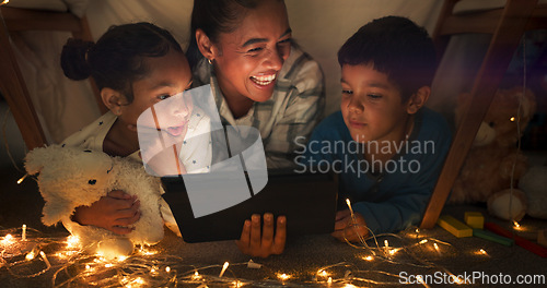 Image of Funny, tablet and mother with children in a tent house streaming internet video, show or movie online in the night. Dark, digital and parent or dad relax with kids watching comedy in the evening