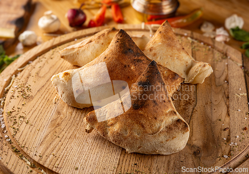 Image of Calzones on wooden board