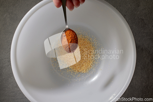 Image of spoon of ground dried paprika spice