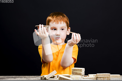 Image of boy with eating chocolate waffles