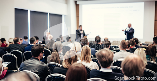 Image of I have a question. Group of business people sitting in conference hall. Businessman raising his arm. Conference and Presentation. Business and Entrepreneurship