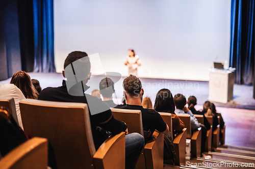 Image of Woman giving presentation on business conference event.