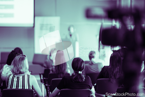 Image of Woman giving presentation on business conference event.
