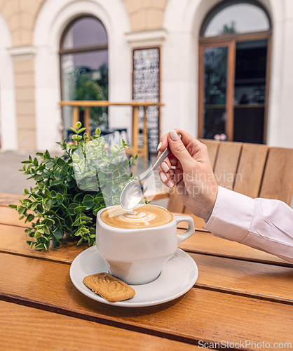 Image of Businesswoman holding art coffee