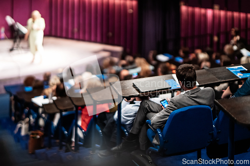 Image of Woman giving presentation on business conference event.