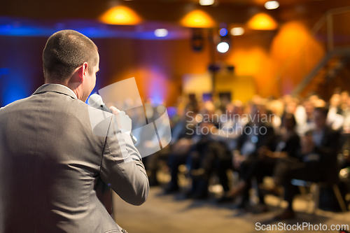 Image of Public speaker giving talk at Business Event.
