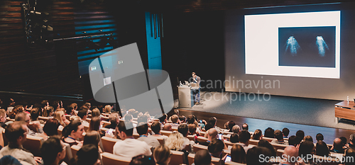 Image of Business speaker giving a talk in conference hall.