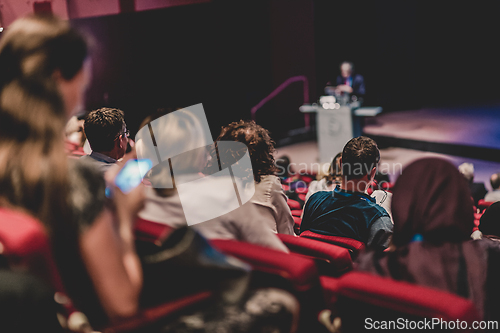 Image of Business speaker giving a talk in conference hall.