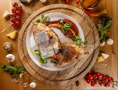 Image of Delicious calzone on a wooden board
