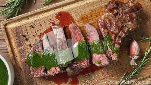 Image of freshly grilled sliced steak with green parsley sauce