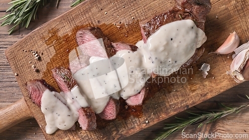 Image of freshly grilled sliced beef steak with pepper sauce 