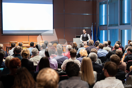 Image of Business speaker giving a talk at business conference meeting event.
