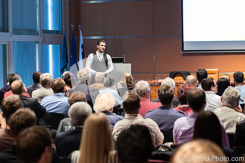 Image of Business speaker giving a talk at business conference meeting event.